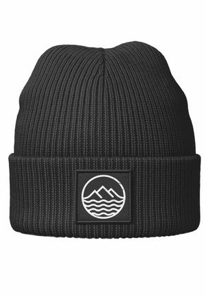 Black ribbed knit beanie with a folded cuff. Features a white patch with a mountain and wave graphic, providing a textured and durable appearance.