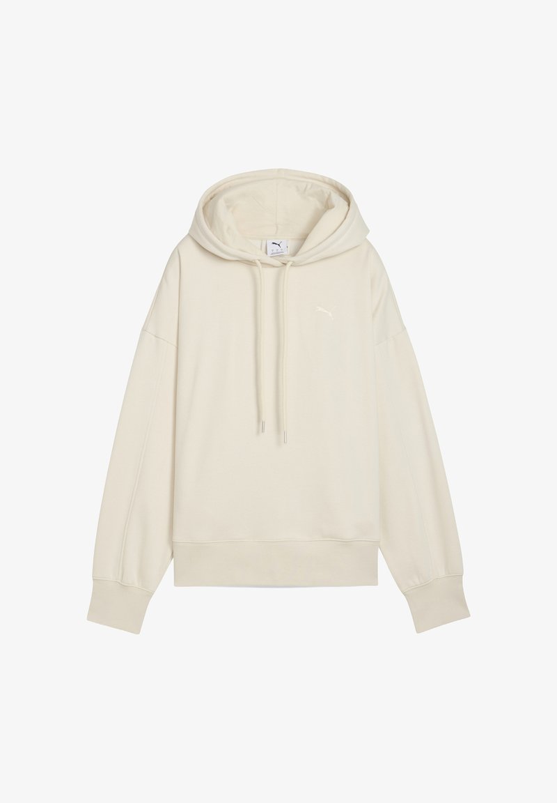 Krémová mikina s kapucňou a voľným strihom, so šnúrkou a lemovaním. Má malú, tónovanú značku na hrudníku. Jemná textúra látky.