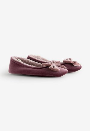 Velvet pink slippers with a soft fur lining, flat soles, pointed toes, and a flattened bow accent on the front.