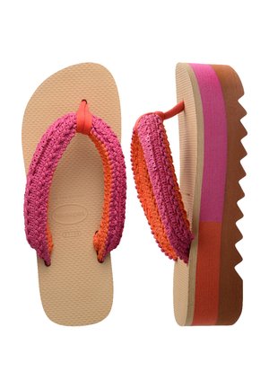 Platform flip-flops with a multicolored woven strap in pink and orange, tan textured sole, and distinctive zigzag edge.