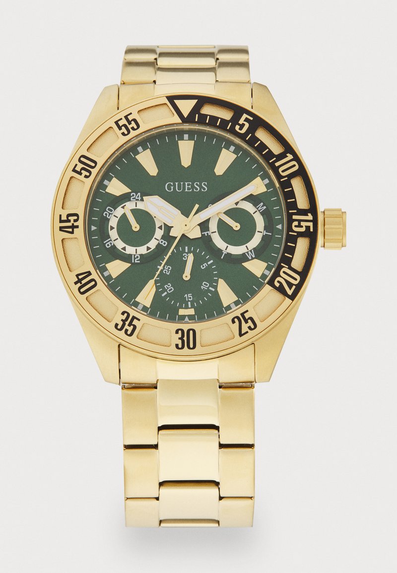 Orologio in metallo color oro con quadrante verde, dotato di grandi indicatori delle ore, sotto-quadranti cronografici e bracciale a maglie. Include una lunetta girevole.