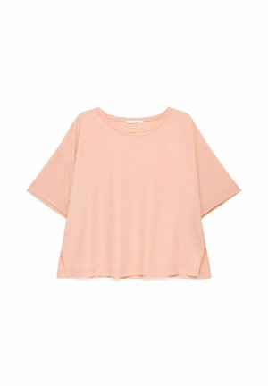 Chemise rose clair, coupe ample, manches courtes, col rond et petites fentes latérales à l’ourlet.