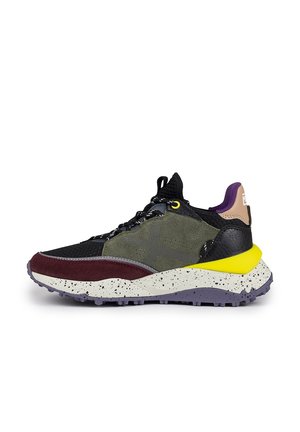 Multicolored sneaker featuring a blend of black mesh, green fabric, and purple accents. Speckled midsole and textured rubber outsole.