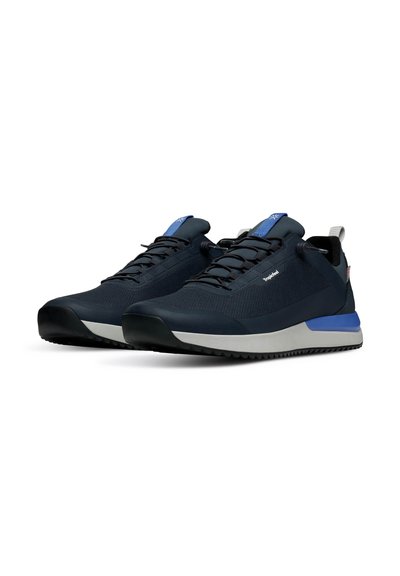 Navy blue athletic shoes with textured mesh upper, grey rubber outsole, blue accent on midsole, and toggle laces for easy adjustment.