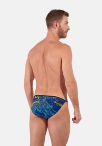 Blaue und gelbe marmorierte Schwimmshorts mit niedrigem Schnitt und kontrastierendem Bund, die eine glatte, elastische Textur und eine enge Passform zeigen.