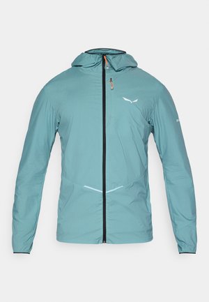 Ľahká, tyrkysová bunda s predným zipsom, nastaviteľnou kapucňou a reflexnými akcentmi. Disponuje elastickými manžetami a štíhlym dizajnom.