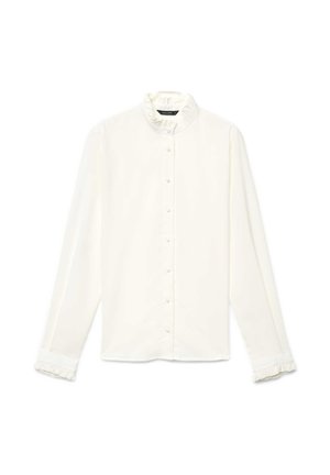 Blouse blanche à manches longues avec un col haut à volants, une fermeture à boutons sur le devant et des poignets à volants. Confectionnée dans un tissu lisse. Design simple et classique.