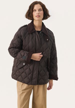 Brown quilted jacket with a corduroy collar and cuffs, featuring a zip closure and snap buttons. The fabric has a textured, padded design.