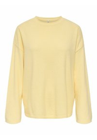 Pull-over jaune en tissu doux, avec un col rond, des épaules tombantes et des manches longues avec des poignets côtelés.