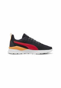 Baskets de sport noires avec un élément de design rouge, un accent orange au talon, une tige en mesh léger et une semelle blanche avec des détails texturés.
