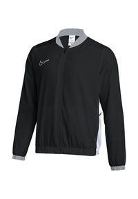 Black Nike jacket with a gray collar, full zipper, and elastic cuffs. Features side pockets and white logo on the chest, made of lightweight material.
