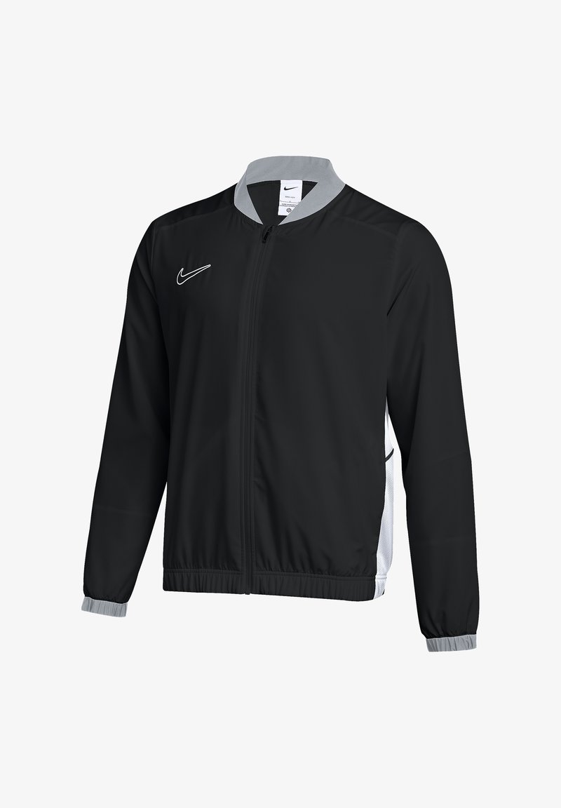 Black Nike jacket with a gray collar, full zipper, and elastic cuffs. Features side pockets and white logo on the chest, made of lightweight material.