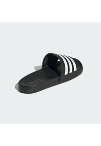 Black slide sandal with a flat sole, featuring three white stripes across the upper and a textured black outsole for grip.
