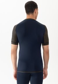 Navy short-sleeve athletic top with charcoal gray accents, fitted design, smooth texture, and contrasting stitching along the seams.