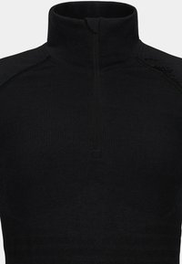 Black, high-neck pullover with a quarter zip, textured fabric, and reinforced seam accents. Simple, fitted design.