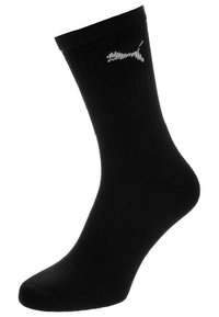 Calcetín negro de crew con puño acanalado que presenta un pequeño logo blanco de Puma en el lado exterior.