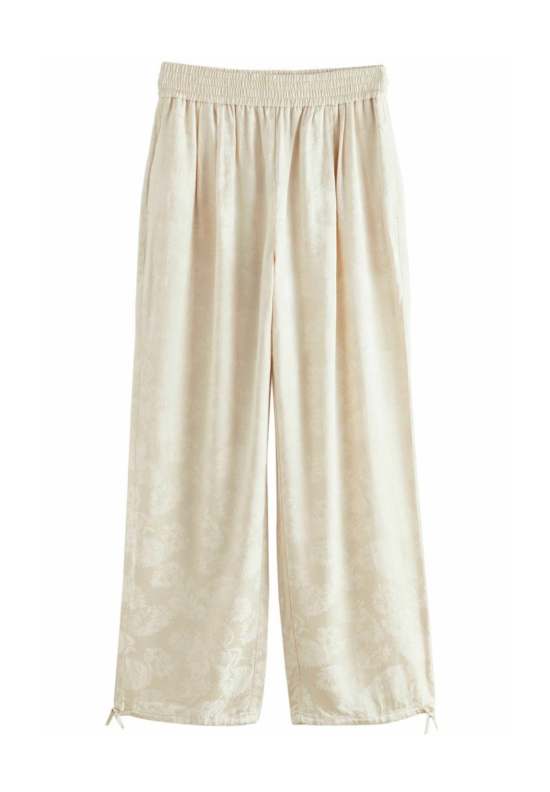 Pantaloni a gamba larga color beige chiaro con vita elasticizzata, caratterizzati da un delicato motivo floreale e lacci sul fondo per una lunghezza regolabile.