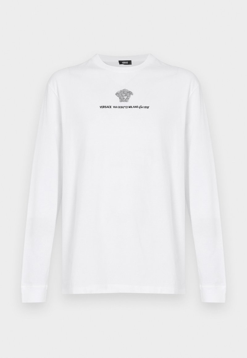 Bela bomba z dolgimi rokavi iz bombaža z imprimiranem Versace logotipom in Medusa grafiko v črni barvi, okrogla ovratnica in standarden kroj.