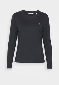 Zwarte lange mouwen katoen t-shirt met een ronde hals. Beschikt over een klein geborduurd logo op de borst en een rechte zoom. Zachte textuur.