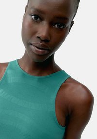 Turquoise mouwloos top met gestructureerde strepen, een ronde hals en een nauwsluitend ontwerp, met gladde stof en minimalistische styling.