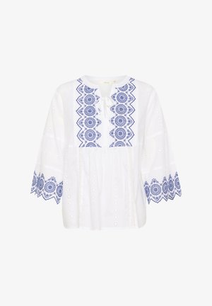 Blouse en coton blanc avec des motifs floraux brodés bleus, col rond, cordon de serrage et manches larges avec des accents en dentelle.