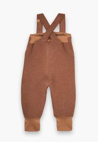 Braune Wollmischung Latzhosen mit überkreuzten Trägern, weichen sandfarbenen Akzenten, schmal zulaufenden Beinen und elastischen Bündchen für einen engen Sitz.