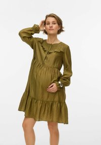 Oliiviroheline, pika varrukaga kleit, millel on volangidega kaelus ja kihiline alläär. Esiküljel nupud ja tekstuuriga kangas.