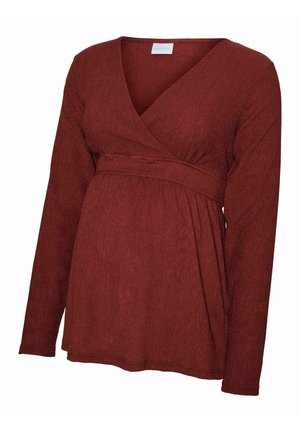 Langsleeve, wikkelstijl zwangerschapstop van een gestructureerde, roestkleurige stof. Heeft een aansluitende taille en een zachte, vloeiende silhouet.