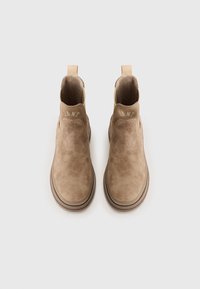Beige Wildleder-Ankle-Boots mit elastischen Seitenteilen, runder Zehenpartie und flacher Gummisohle. Gestickte Details in der Nähe der Ferse.