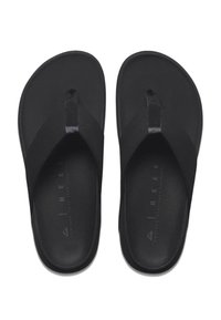 Des tongs noires en matériau doux, avec une sangle entre les orteils et une semelle légèrement texturée. Design minimaliste avec une finition lisse.