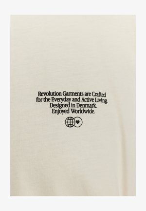 Cream-colored cotton t-shirt featuring black text reading about its design, with a globe and heart graphic. Smooth texture and simple design.