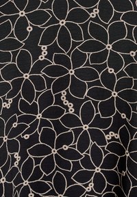 Black fabric featuring a floral pattern in cream, with stylized flowers and dots. The design is continuous with clear outlines and details.