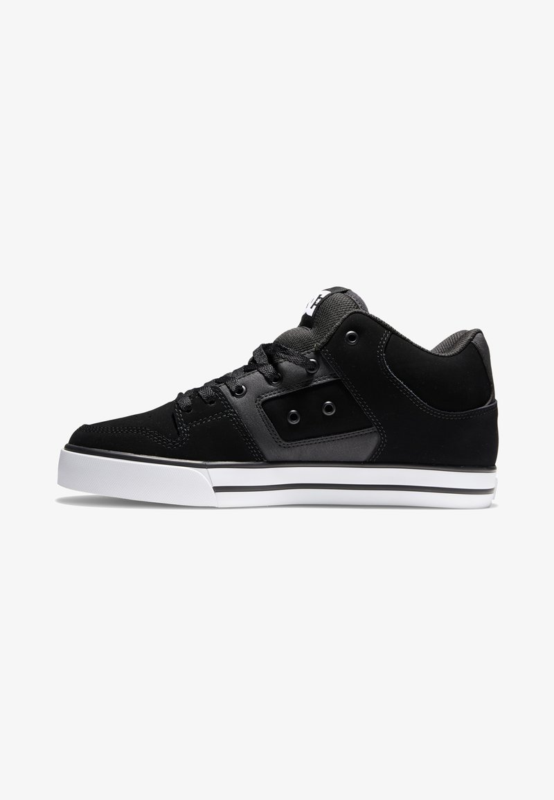 Black sneaker with a textured upper, round toe, contrasting white sole, and two eyelets for laces. Features a logo on the tongue.
