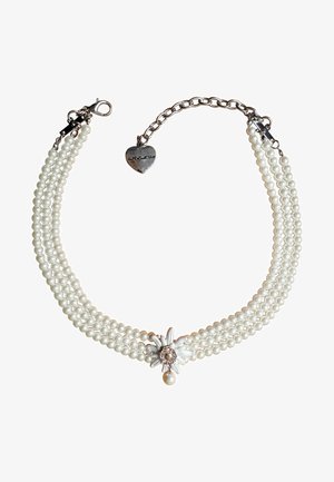Three-strand pearl necklace featuring a silver flower-shaped accent and a dangling pearl, secured with a metal chain and heart charm.