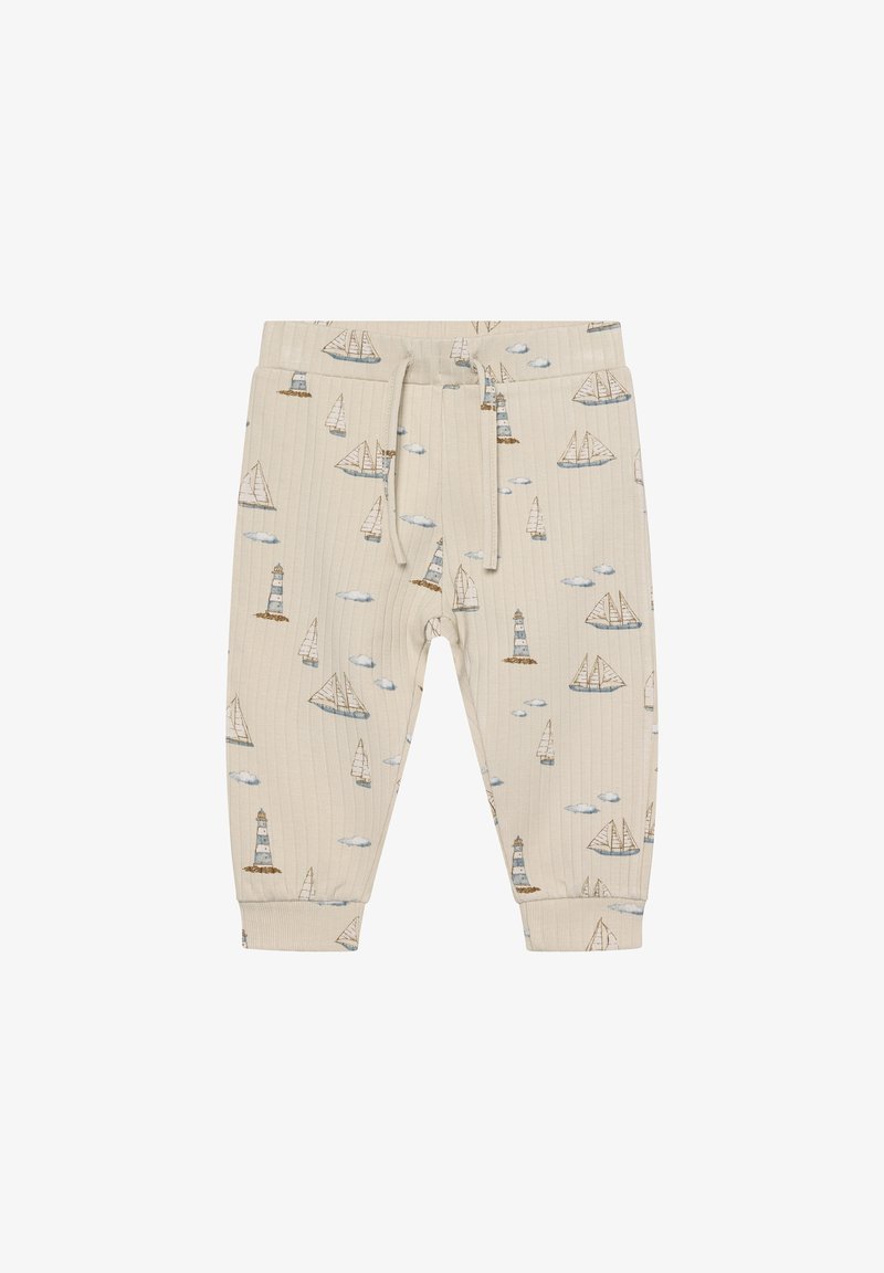 Beige ribbed pants with nautical print featuring boats, lighthouses, and clouds. Elastic waistband with drawstring and elastic cuffs.