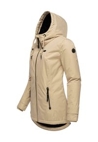 Beige waterproof jacket with a hood, drawstrings, and black zipper details. Features a smooth texture and a soft-lined interior.