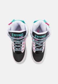 Adidașii înalți au un design alb și negru cu accente de teal și roz. Materialul texturat de culoare neagră, șireturile multicolore și umplutura sunt vizibile.