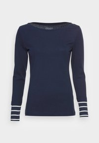 Marinblå långärmad skjorta med vita horisontella ränder vid ärmsluten, rund halsringning och slim fit i ekologisk bomull.