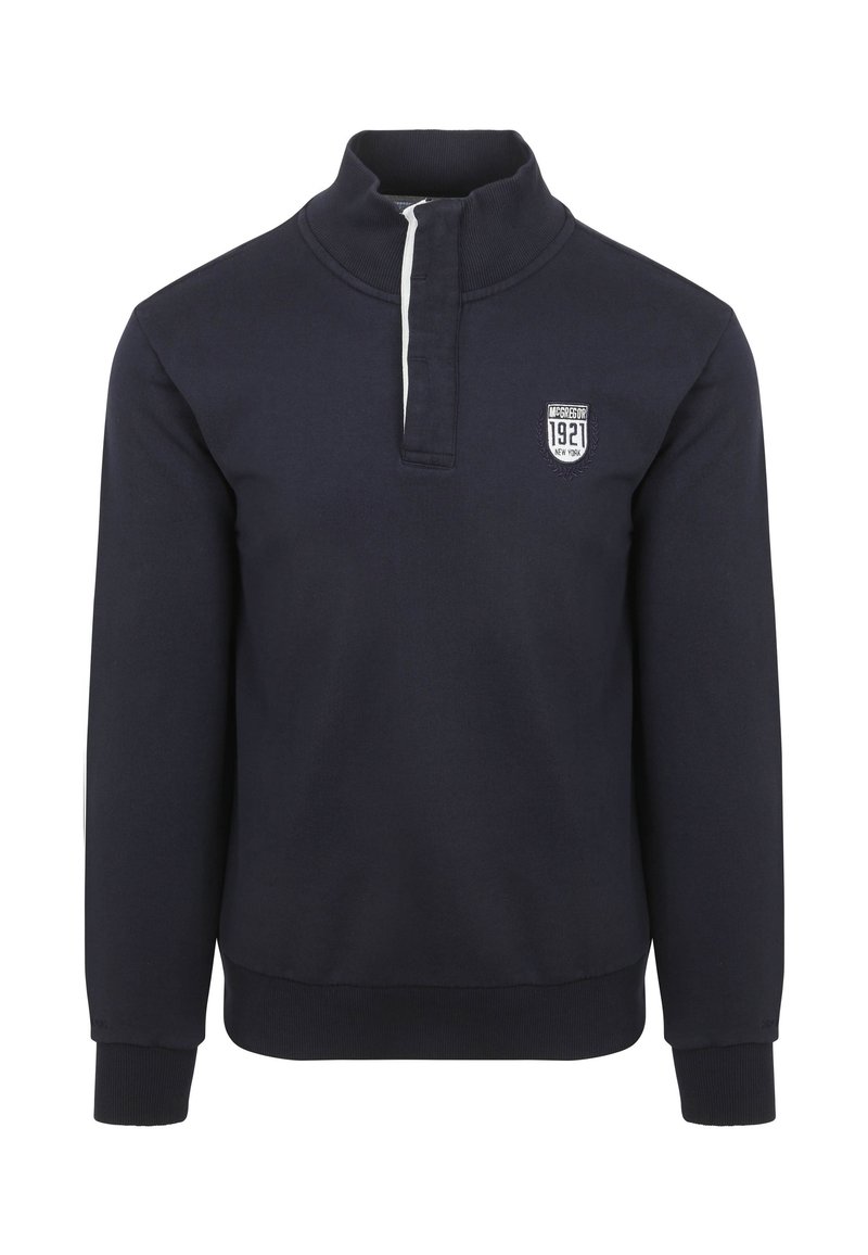 Marineblauwe pullover sweatshirt met hoge kraag, halve rits aan de voorkant en geribde mouwen. Bevat een geborduurd patch op de borst.