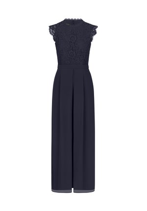 Laivaston haalari, jossa on pitsinen puku, jossa on lyhyet hihat, korkea kaula-aukko ja leveät lahkeet, joissa on laskokset. Valmistettu sileästä kankaasta.