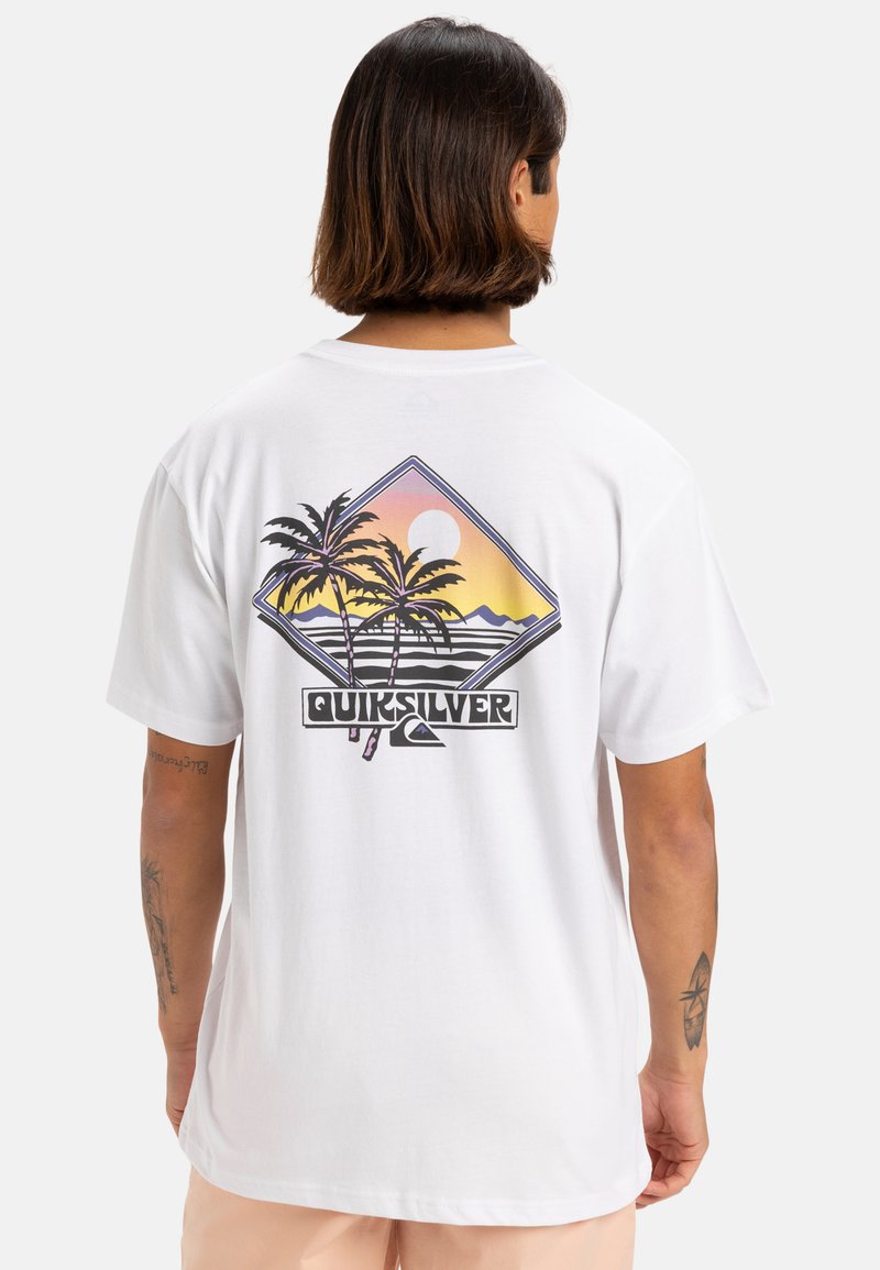 Camiseta de algodón blanca con un gráfico colorido de una palmera y un motivo de sol en la parte trasera, con el logo de "Quiksilver" en la parte inferior.