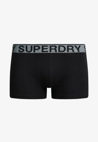 Boxers de algodón negros con una cinturilla elástica gris que presenta "SUPERDRY" en letras negritas negras. Textura suave, diseño ajustado.