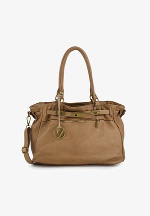 Brown leather handbag with dual handles, adjustable shoulder strap, brass accents, zippered pockets, and a circular logo charm.