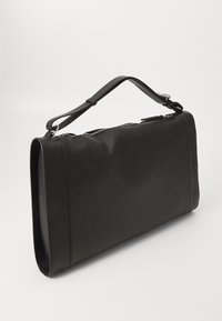 Black leather rectangular shoulder bag with a thick adjustable strap and a top zipper closure.