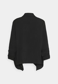 Musta pitkähiha jacketti, jossa on kaulus ja röyhelöidyt hihat, esitettynä takaa valkoisella, yksinkertaisella taustalla.