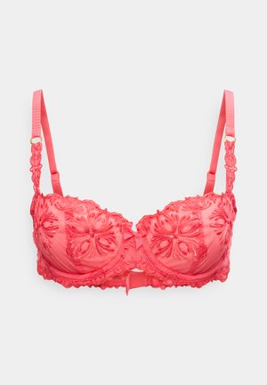 Korallinpunainen pitsinen toppaliivit kukkaompeleella, säädettävillä olkaimilla ja etuosassa keskellä olevalla rusettikoristeella valkoisella taustalla.