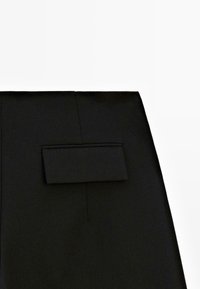 Czarne spodnie o prostym kroju, z kieszenią z patką z tyłu, wykonane z gładkiego materiału, w minimalistycznym stylu, bez widocznych elementów metalowych.