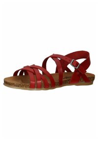 Sandal de cuero rojo con correas cruzadas anchas, una correa con hebilla en el tobillo y una plantilla de corcho. La suela es ligeramente translúcida y plana.