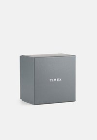 Gray cardboard box with a matte finish, featuring the text "TIMEX" in white on the front. Square shape with a openable flap.