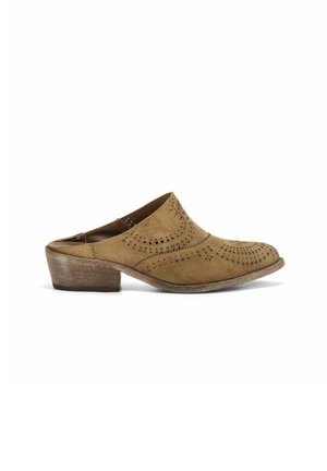 Mule in camoscio marrone slip-on con tacco basso impilato e dettagli decorativi traforati sulla tomaia.